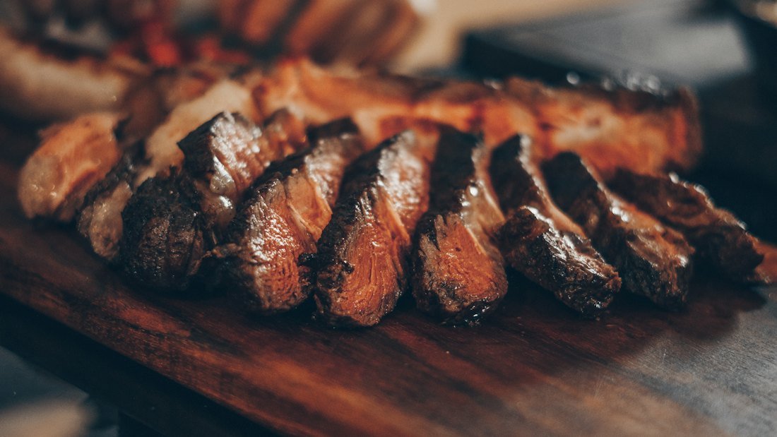 Sliced grilled steak on a board