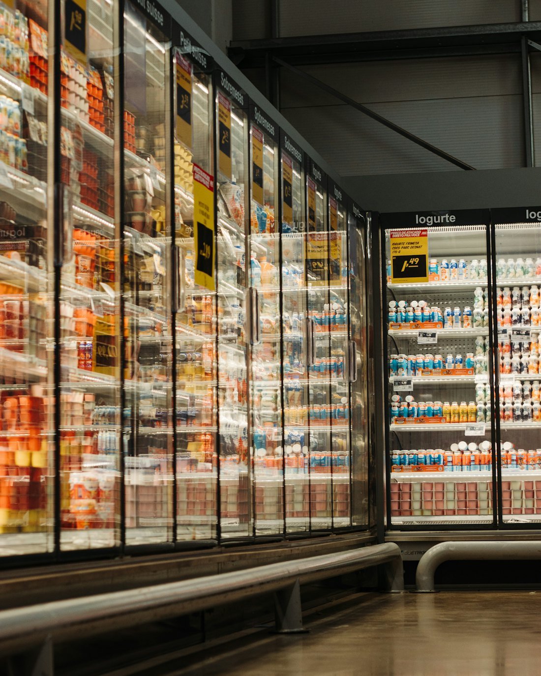 Refrigerated meat cases in a supermarket aisle